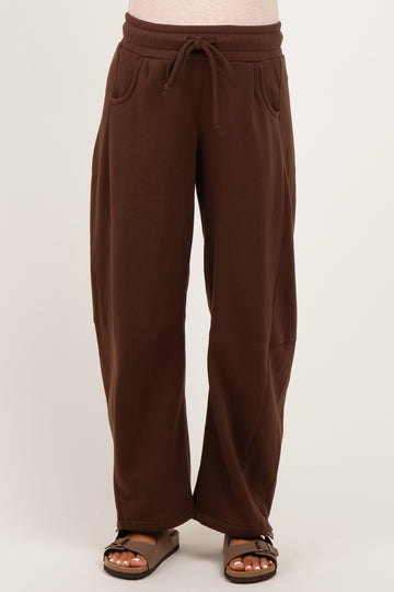 woman wearing brown maternity wide-leg sweatpants with drawstring waist and side pockets