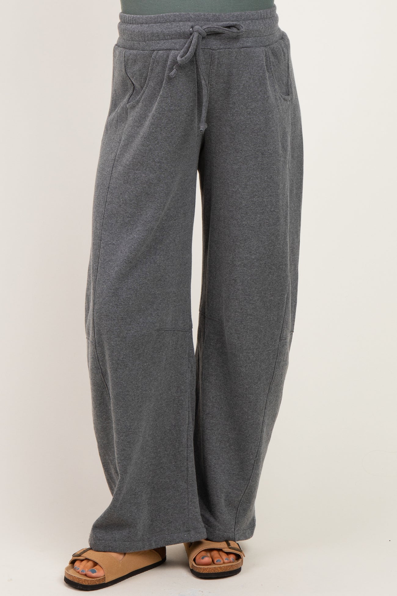 woman wearing gray maternity sweatpants with a drawstring waist and side pockets