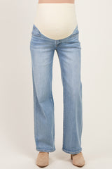 woman wearing light blue maternity jeans with a beige over-the-belly panel