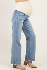 woman wearing light blue maternity jeans with a supportive over-the-bump waistband and a visible baby bump