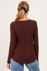 woman wearing a burgundy ribbed long sleeve maternity top, seen from the back