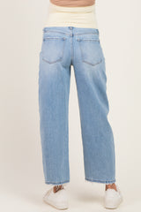 woman wearing light wash maternity jeans with a high waistband and relaxed fit, showing the back view