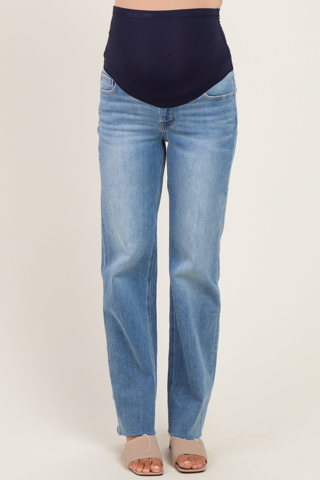 woman wearing light blue maternity jeans with a dark blue over-the-bump waistband