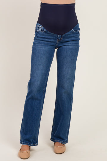 woman wearing a pair of dark blue maternity jeans with a stretchy over-the-bump waistband and flared legs