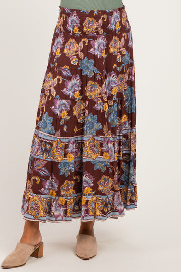 woman wearing a bohemian floral print maternity maxi skirt with an elastic waistband