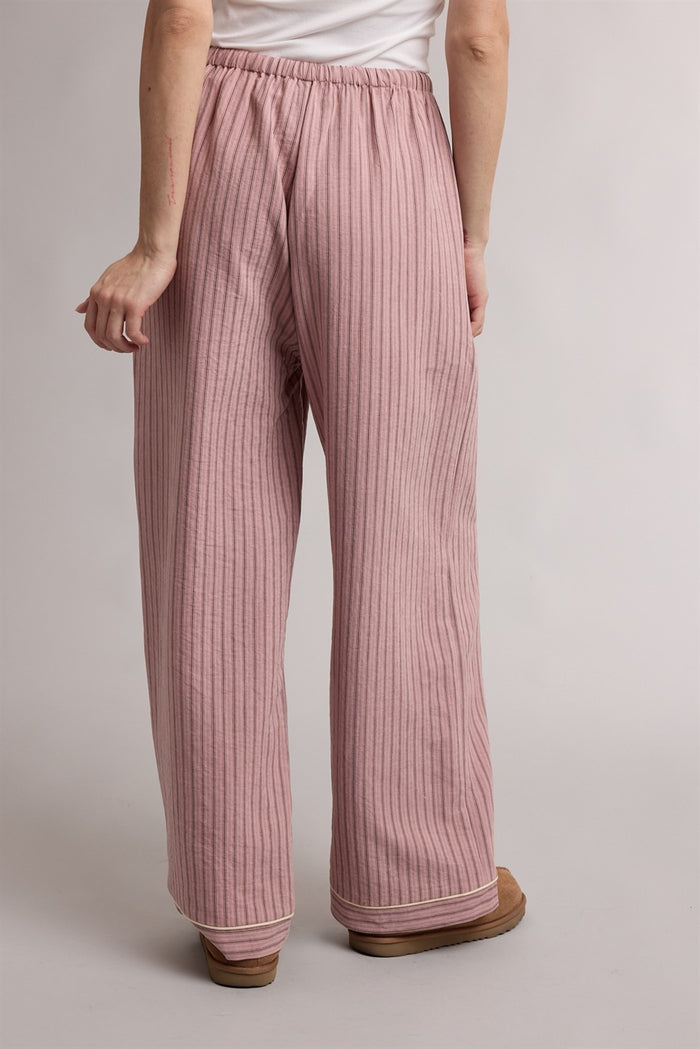 woman wearing loose-fitting pink striped wide-leg pants with an elastic waistband
