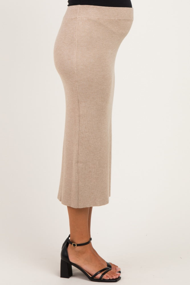 woman wearing a beige ribbed midi maternity skirt with a visible baby bump