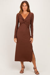 woman wearing a brown long sleeve maxi dress with a twist front and a side slit