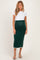 woman wearing a white short sleeve top and a green knit maternity skirt with side detail, showcasing her baby bump