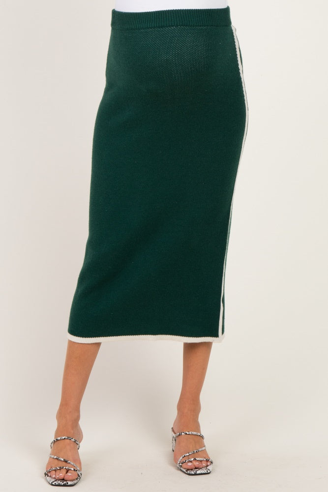woman wearing a green knitted maternity skirt with a side stripe detail and a fitted waistband