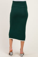 woman wearing a dark green knitted maternity skirt with a fitted waistband and a subtle hem detail