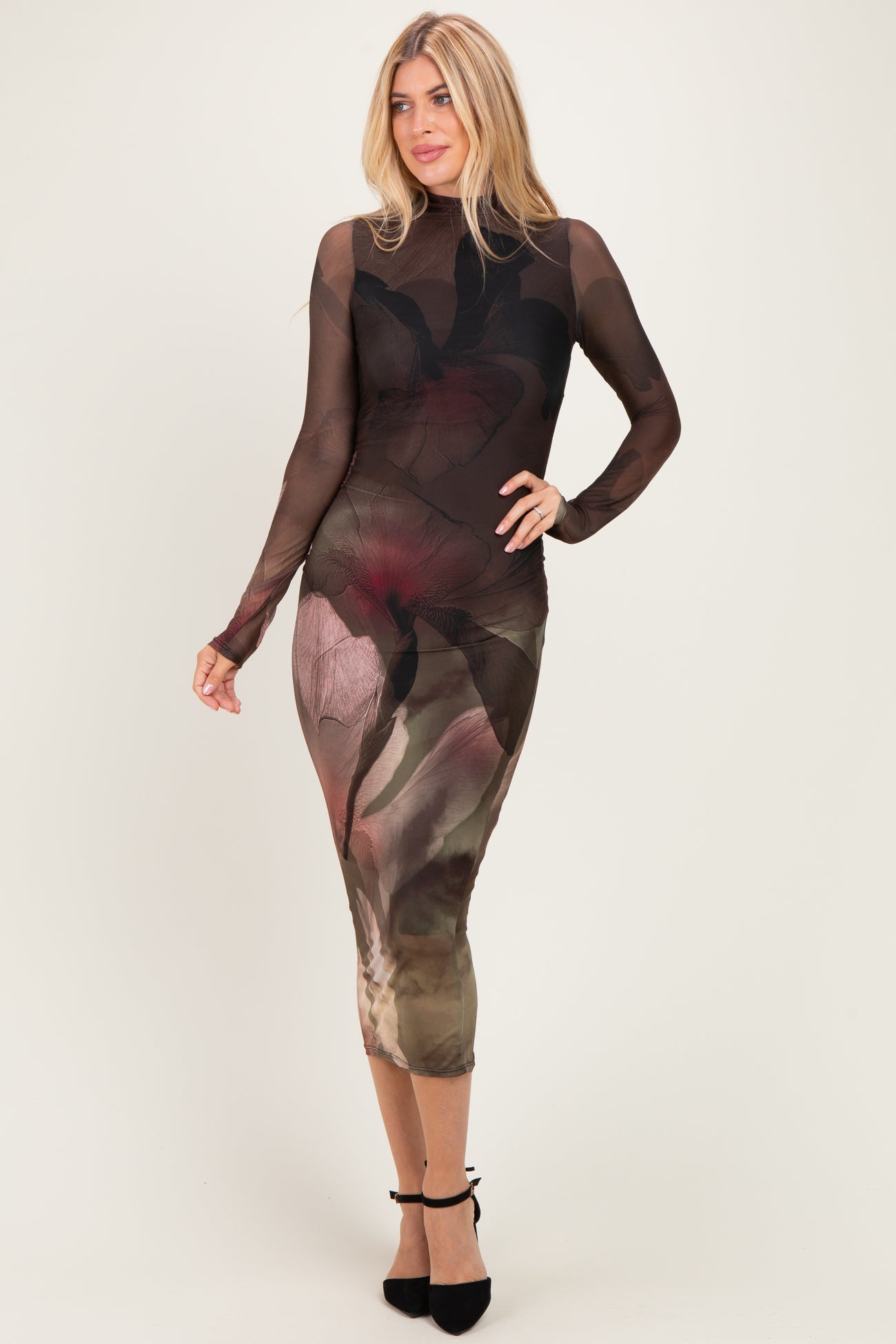 woman wearing a sheer long sleeve floral printed midi dress with a fitted silhouette