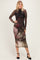 woman wearing a long sleeve sheer floral mesh midi dress with a fitted silhouette and black strappy heels