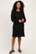 woman wearing a black long sleeve ribbed dress with a relaxed fit and balloon sleeves