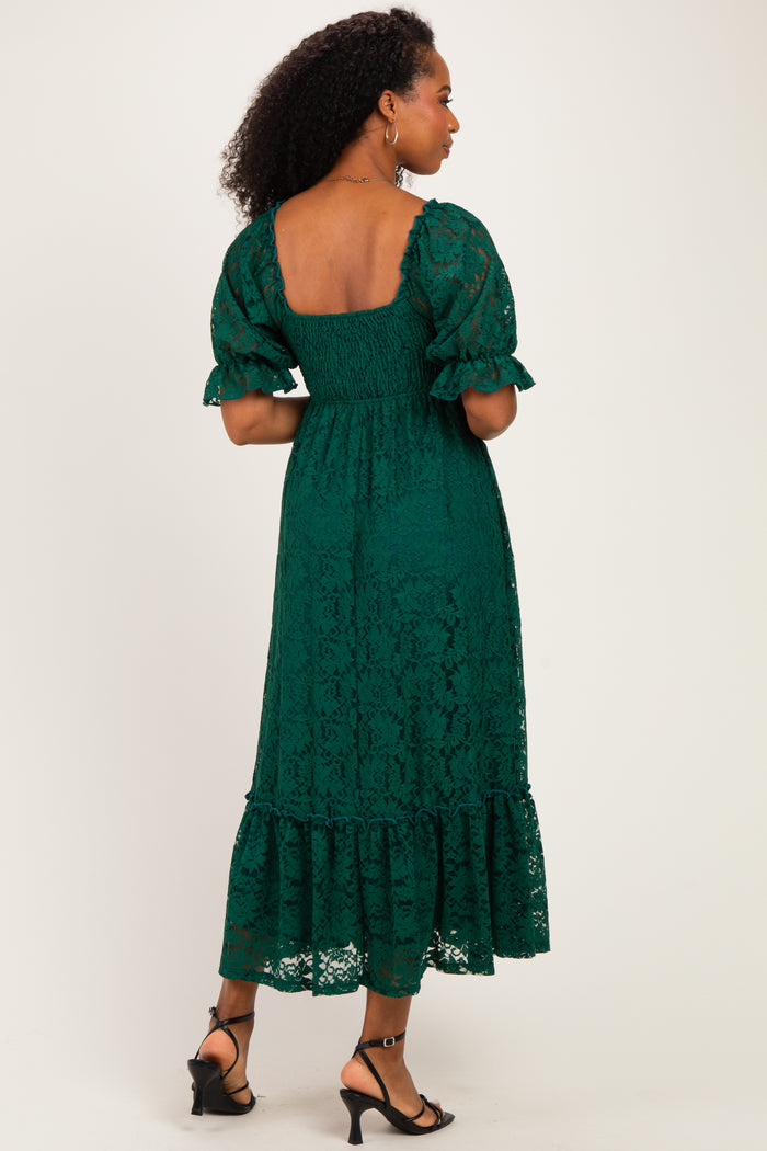 woman wearing a green lace midi dress with a smocked bodice and puff sleeves, showing a ruffled hem and open back