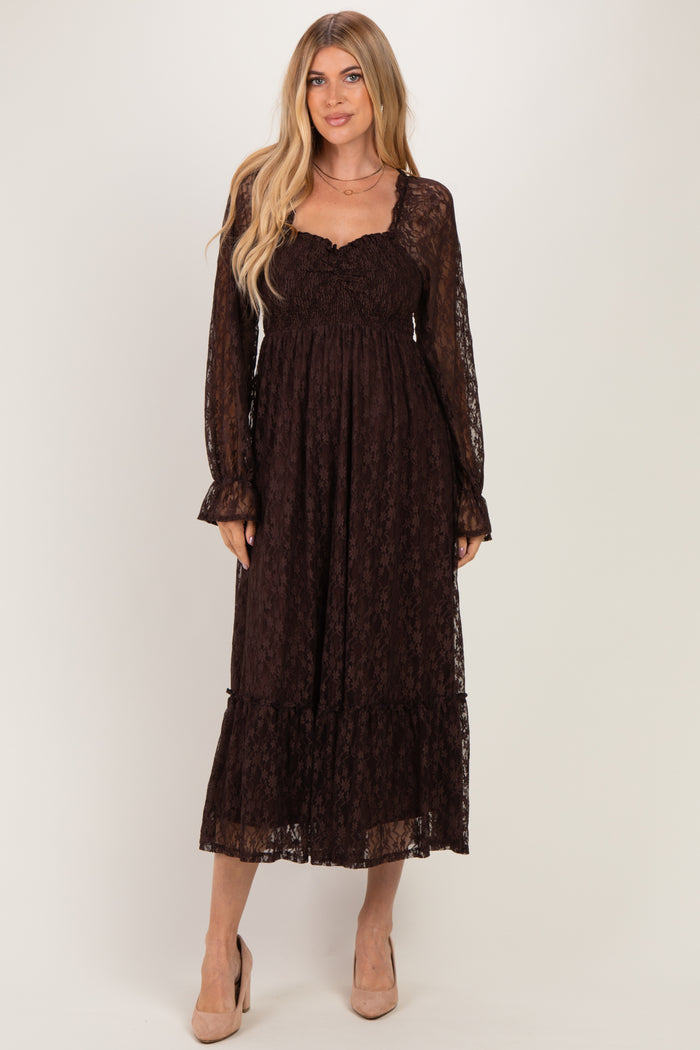 woman wearing a dark brown lace long sleeve maxi dress with a smocked bodice and tiered skirt