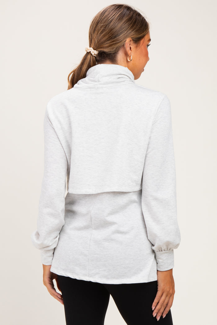 woman wearing a gray maternity sweatshirt with a cowl neck and balloon sleeves, showing the back view
