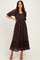 woman wearing a chocolate brown lace maxi dress with puff sleeves and a tiered hem