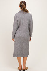 woman wearing a gray long sleeve maternity sweater dress, viewed from the back