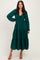 woman wearing a forest green long sleeve maxi dress with a tie front and tiered skirt