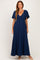 woman wearing a navy blue maxi dress with short flutter sleeves and a fitted bodice