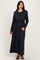 woman wearing a navy blue long sleeve maxi dress with a cinched waist and pockets