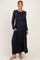 woman wearing a navy long sleeve maternity dress with a waist tie and pockets, and showing her baby bump