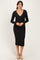 woman wearing a black long sleeve ribbed wrap dress with a fitted silhouette and a v-neckline