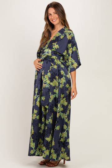 woman wearing a navy floral maternity maxi dress and holding her baby bump