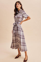 woman wearing a short sleeve plaid midi dress with a tie waist and brown heeled mules