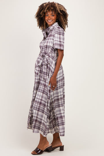woman wearing a purple plaid maternity dress with short sleeves and a tie waist detail