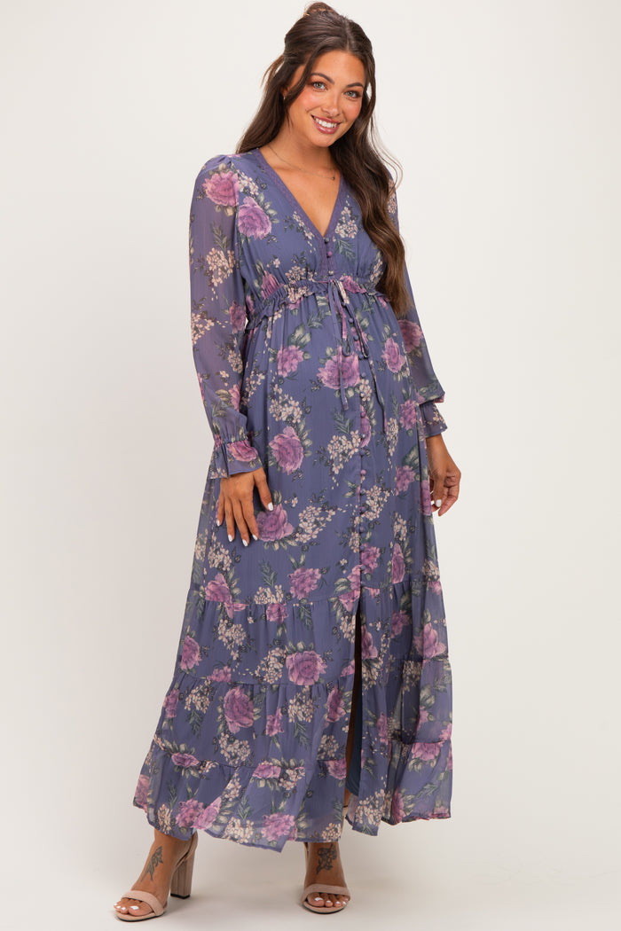 woman wearing a purple floral maternity maxi dress with long sleeves and a cinched waist, showcasing a baby bump