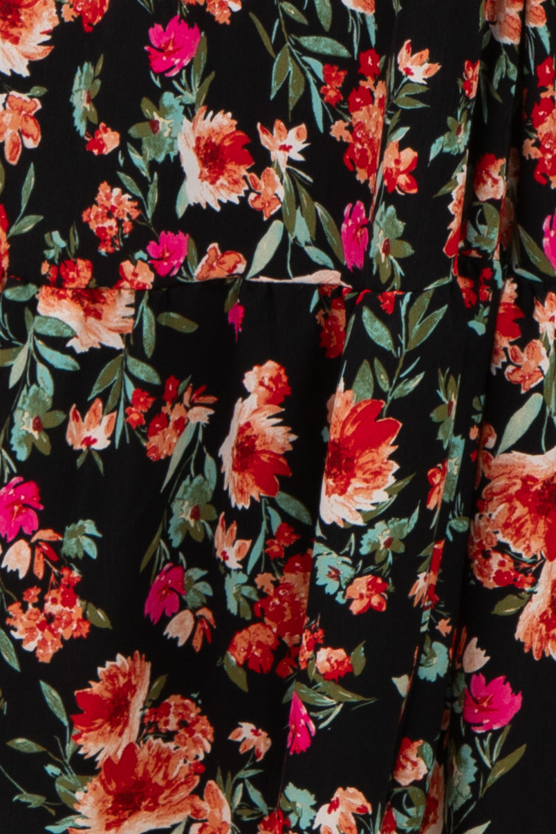 floral print black dress featuring vibrant red and pink flowers with a tiered design