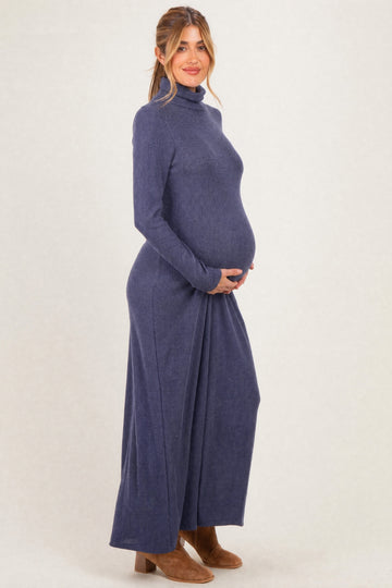 woman wearing a navy long sleeve maternity dress with turtleneck and visible baby bump
