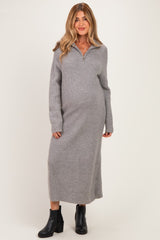 woman wearing a gray long sleeve maternity sweater dress with a collar and a visible baby bump