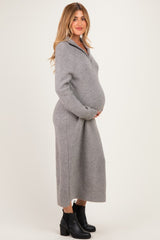 woman wearing a gray ribbed zip-up maternity dress and showing her baby bump