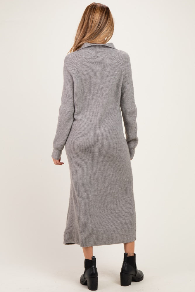 woman wearing a long gray maternity sweater dress with a fitted silhouette and a collar, viewed from the back