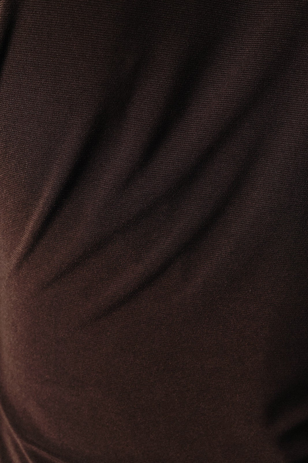 close-up of a dark brown stretch fabric showing smooth texture and subtle sheen