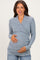 woman wearing a blue heather wrap maternity top and holding her baby bump