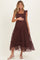 woman wearing a burgundy maternity dress with ruffle detail and tiered design, gently holding her baby bump