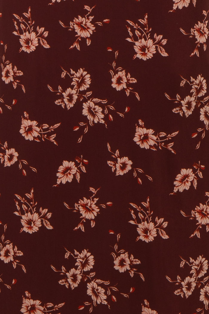 burgundy floral fabric with peach flowers and green leaves throughout