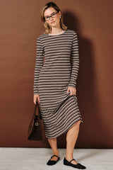 woman wearing a long sleeve brown striped midi dress with a scoop neckline and black flats, holding a brown bag