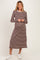 woman wearing a long sleeve brown and cream striped maternity dress with a relaxed fit