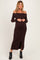 woman wearing a brown off-shoulder ribbed maternity dress with button details and a visible baby bump
