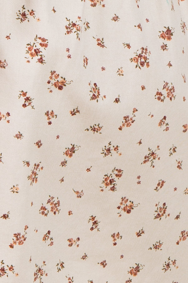 floral print fabric with small pink and brown flowers on a cream background