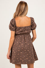 woman wearing a brown floral maternity dress with puff sleeves and a fitted waist, showing a casual and comfortable style