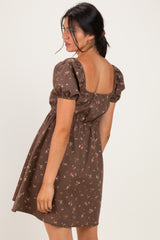 woman wearing a brown floral puff sleeve dress with a square back and gathered waist