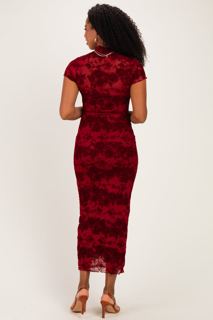 woman wearing a fitted burgundy lace dress with short sleeves and a midi length, showing the back view