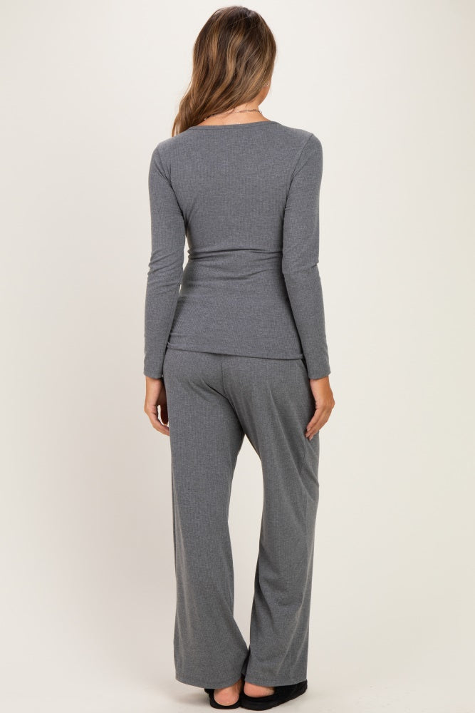 woman wearing a gray long sleeve maternity top and matching pants, showing a comfortable fit from the back