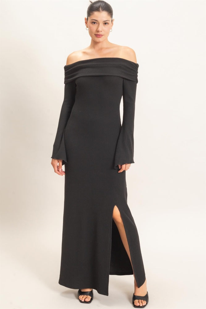 woman wearing a black off-shoulder ribbed maxi dress with long sleeves and a side slit